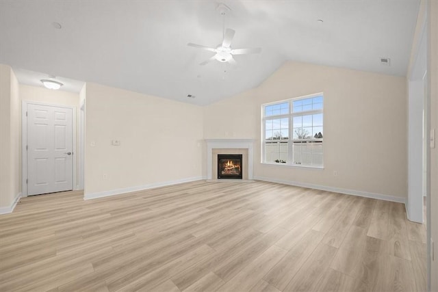 unfurnished living room with vaulted ceiling, light hardwood / wood-style floors, and ceiling fan