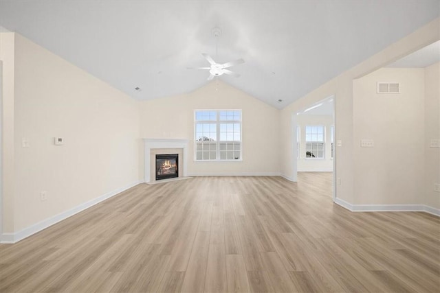 unfurnished living room with ceiling fan, lofted ceiling, and light hardwood / wood-style floors