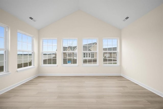 unfurnished sunroom featuring vaulted ceiling