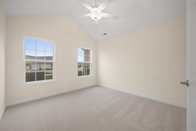 carpeted spare room with vaulted ceiling and ceiling fan