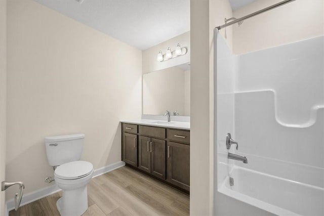 full bathroom featuring shower / bathtub combination, wood-type flooring, toilet, and vanity