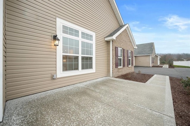 view of side of home with a patio area