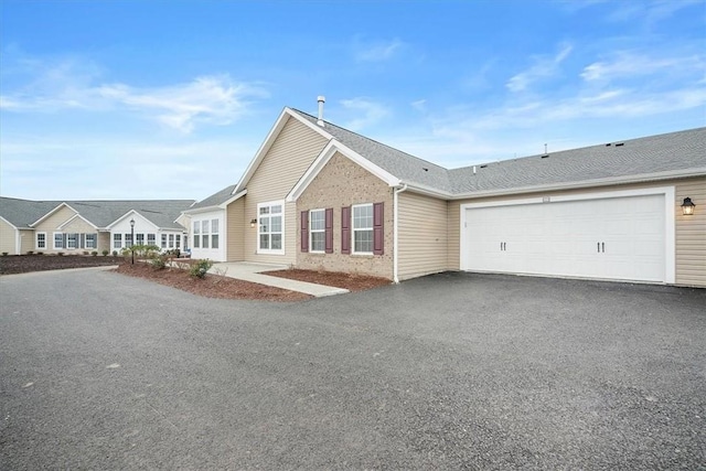 ranch-style home featuring a garage