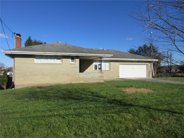 exterior space with a garage and a lawn