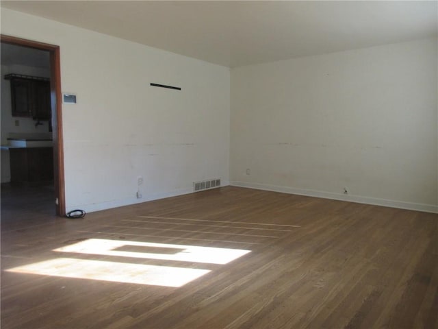 empty room featuring dark hardwood / wood-style flooring