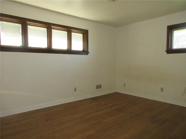 unfurnished room featuring dark hardwood / wood-style floors