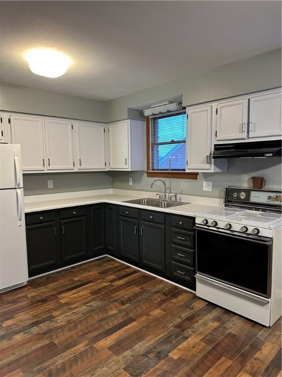 kitchen featuring dark hardwood / wood-style floors, sink, white cabinets, and white appliances