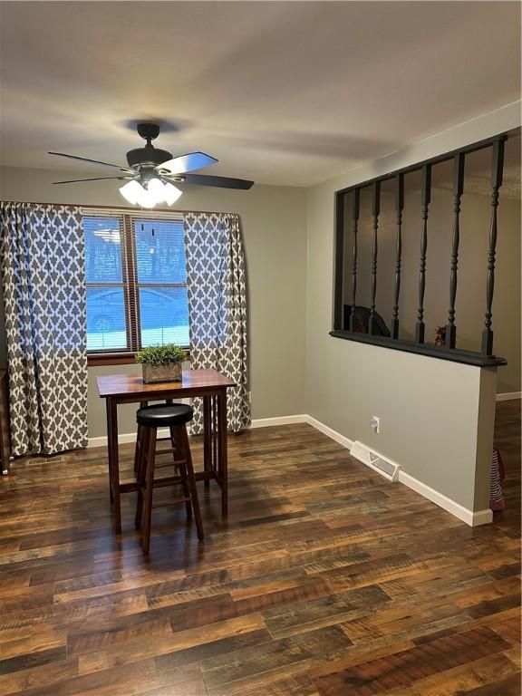 dining room featuring dark hardwood / wood-style flooring and ceiling fan