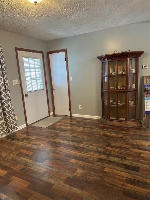 entrance foyer featuring dark hardwood / wood-style floors and a textured ceiling