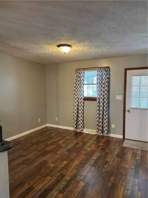 entrance foyer with dark hardwood / wood-style floors and a textured ceiling