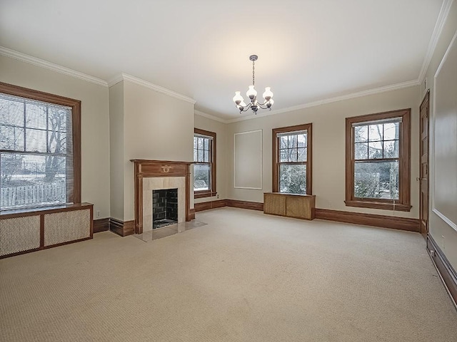 unfurnished living room with ornamental molding, a tiled fireplace, light carpet, and a notable chandelier