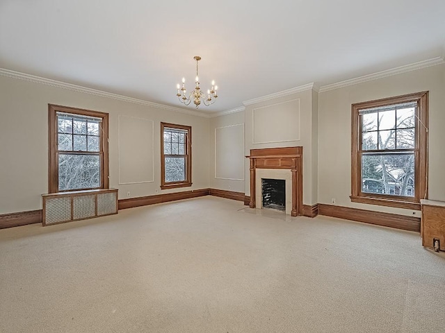 unfurnished living room featuring a notable chandelier, light colored carpet, a wealth of natural light, and ornamental molding