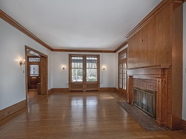 unfurnished living room featuring ornamental molding and dark hardwood / wood-style floors