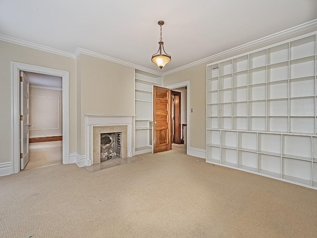 unfurnished living room with ornamental molding, a premium fireplace, carpet floors, and built in features