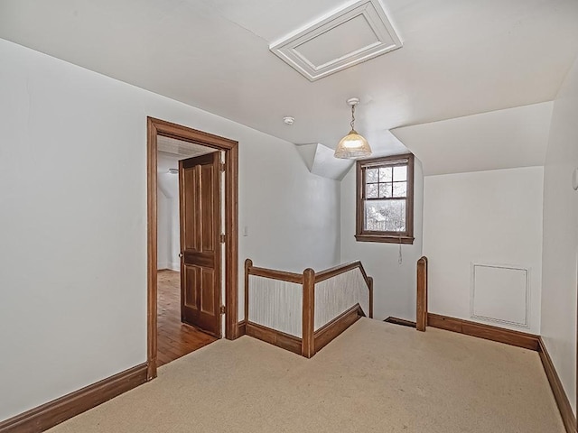 additional living space with vaulted ceiling and carpet