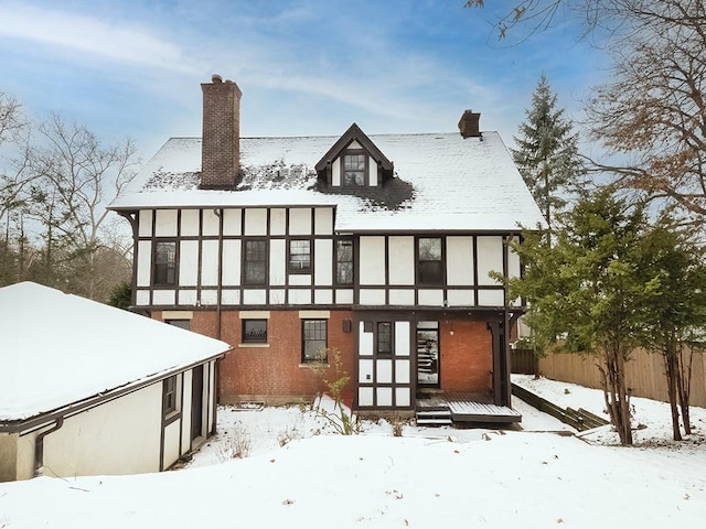 view of snow covered rear of property