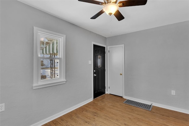 empty room with ceiling fan and light wood-type flooring