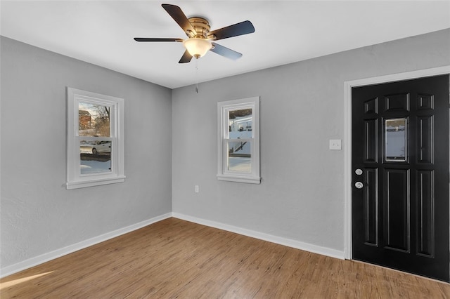 foyer entrance with light hardwood / wood-style flooring and ceiling fan