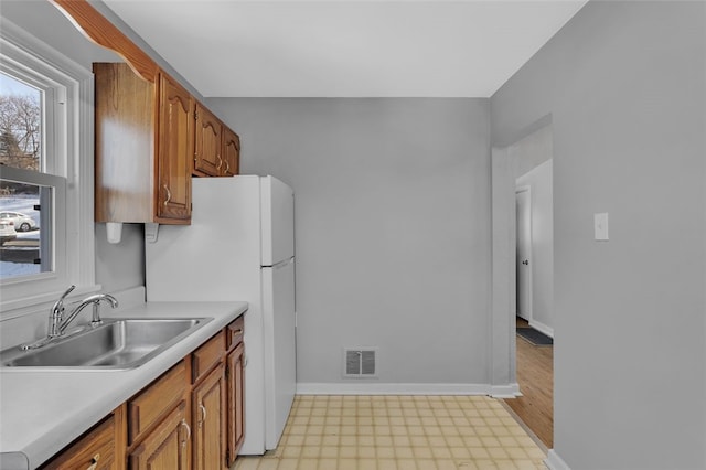 kitchen with sink and white refrigerator