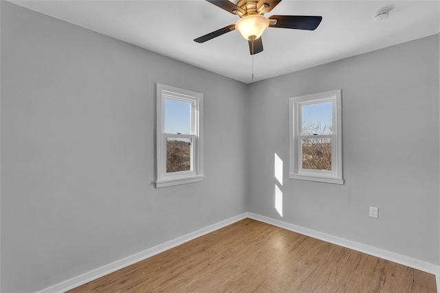 spare room with ceiling fan and light wood-type flooring