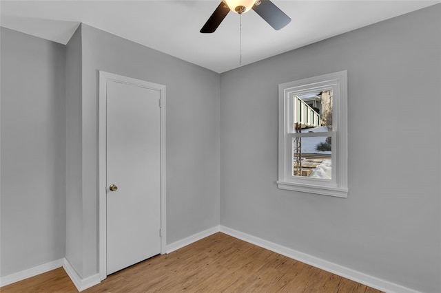 empty room with light hardwood / wood-style flooring and ceiling fan