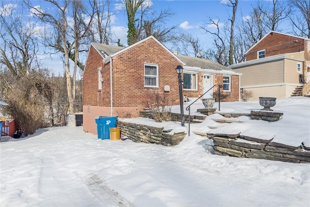 view of snow covered back of property