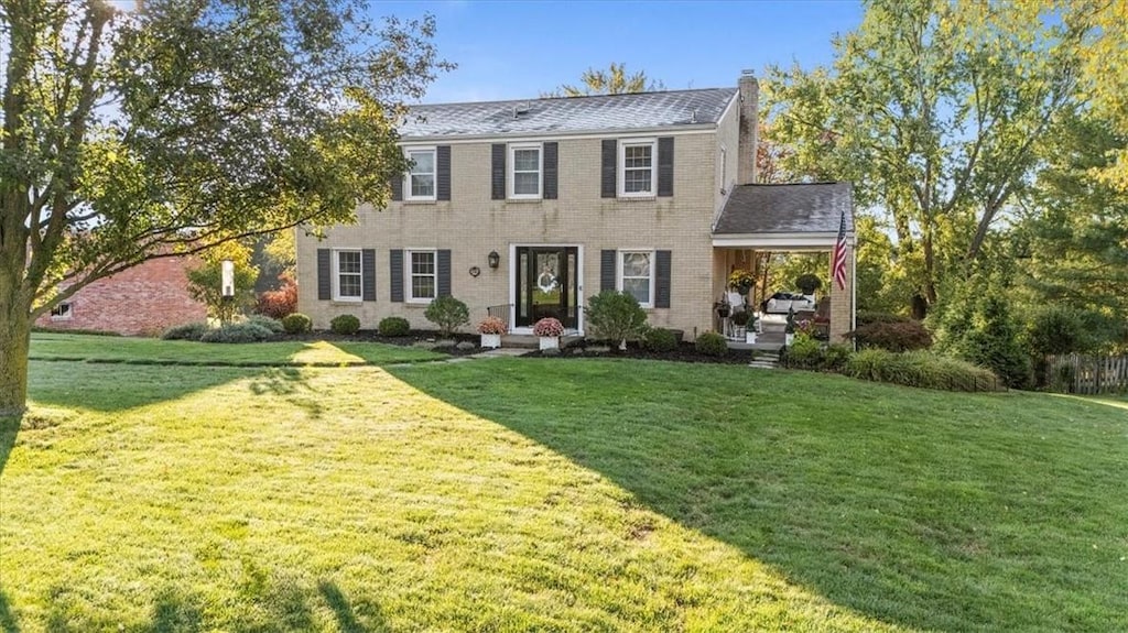 colonial home with a front yard