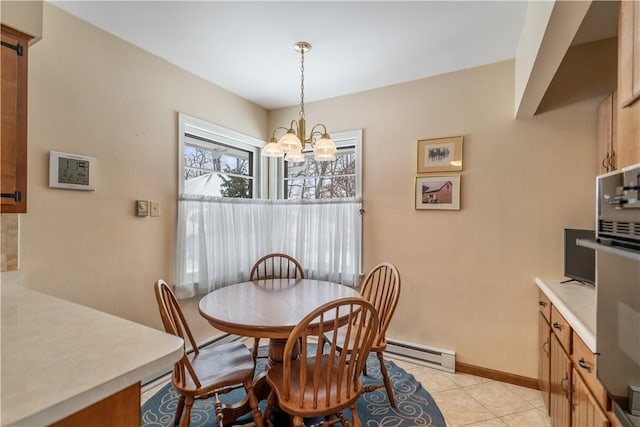 dining area with light tile patterned floors, a baseboard radiator, and a chandelier