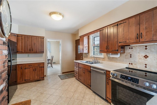 kitchen featuring sink, decorative backsplash, and stainless steel appliances