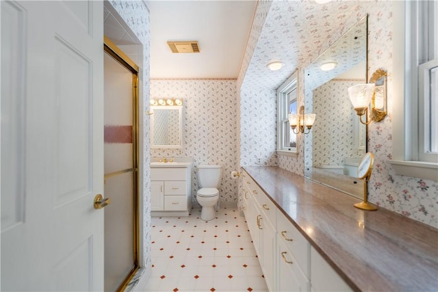 bathroom with vanity, toilet, crown molding, and walk in shower