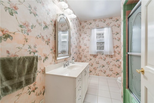 full bathroom featuring vanity, tile patterned floors, shower / bath combination with glass door, and toilet