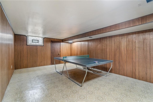 recreation room with wood walls