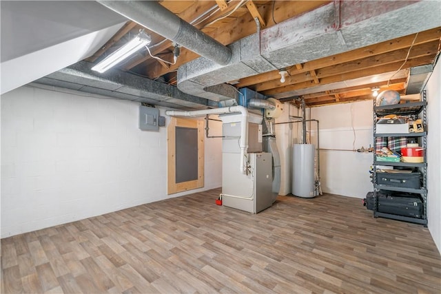 basement with hardwood / wood-style floors, gas water heater, heating unit, and electric panel