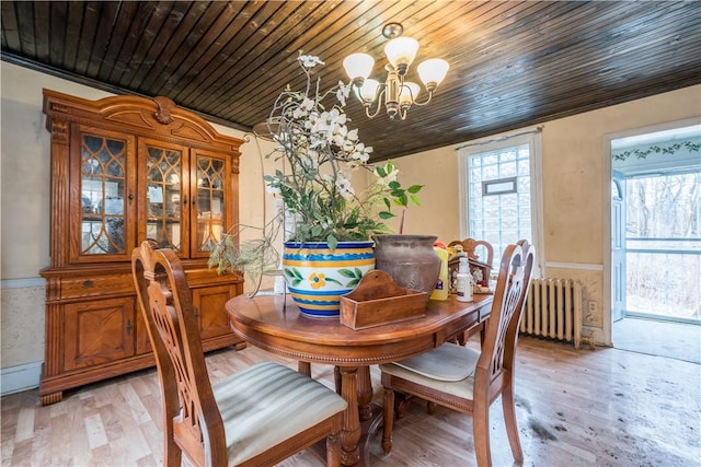 dining room featuring an inviting chandelier, radiator, wood ceiling, and light hardwood / wood-style floors