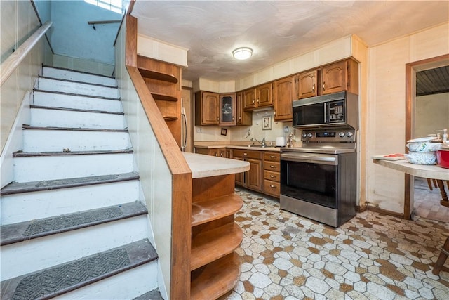 kitchen with stainless steel electric stove and sink