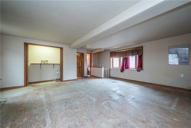 unfurnished room with radiator and beam ceiling