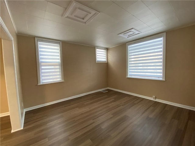 basement featuring ornamental molding and dark wood-type flooring