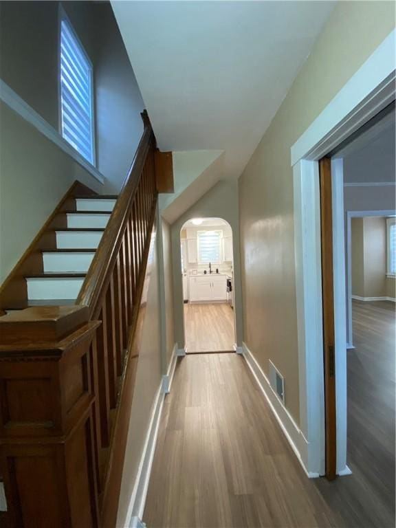 hall with sink and light wood-type flooring