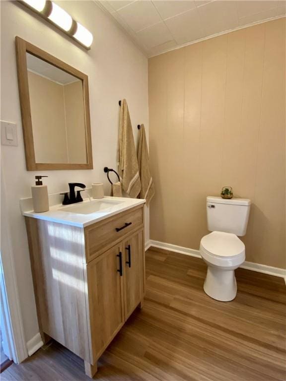 bathroom featuring vanity, hardwood / wood-style floors, and toilet