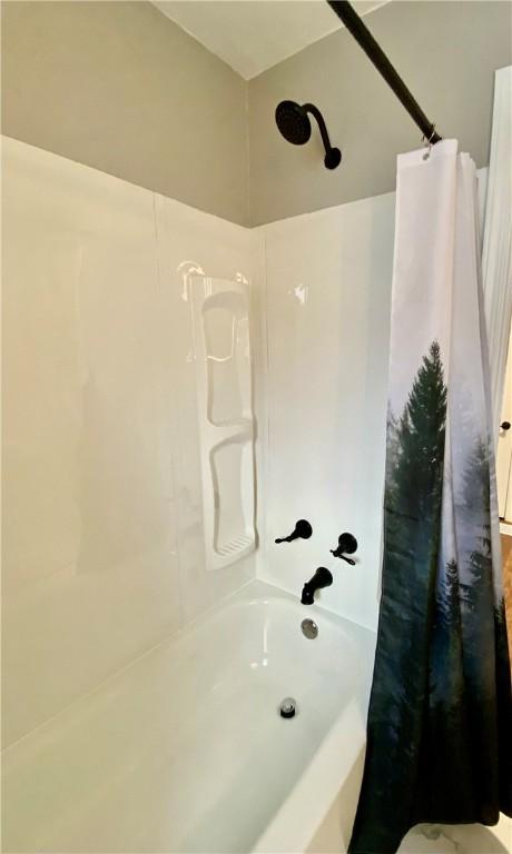 bathroom with shower / bath combo with shower curtain