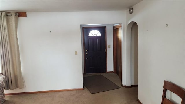 view of carpeted foyer entrance