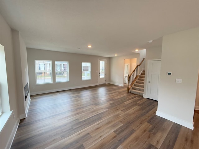 unfurnished living room with dark hardwood / wood-style flooring