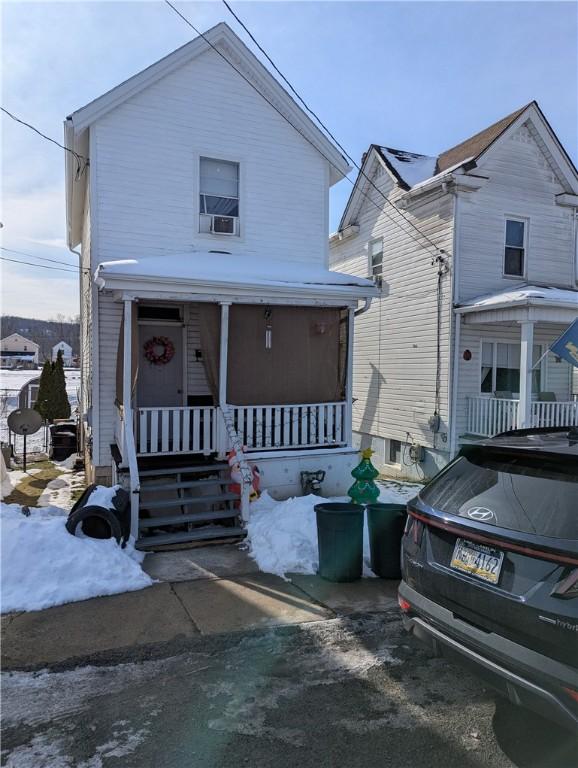 view of front of house featuring cooling unit and a porch