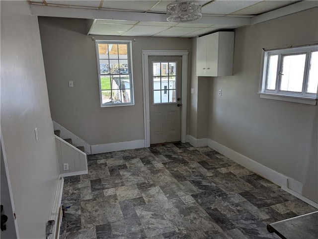 14 2nd Ave, Pt Marion, PA 15474 - doorway to outside featuring stone finish flooring, a drop ceiling, and baseboards