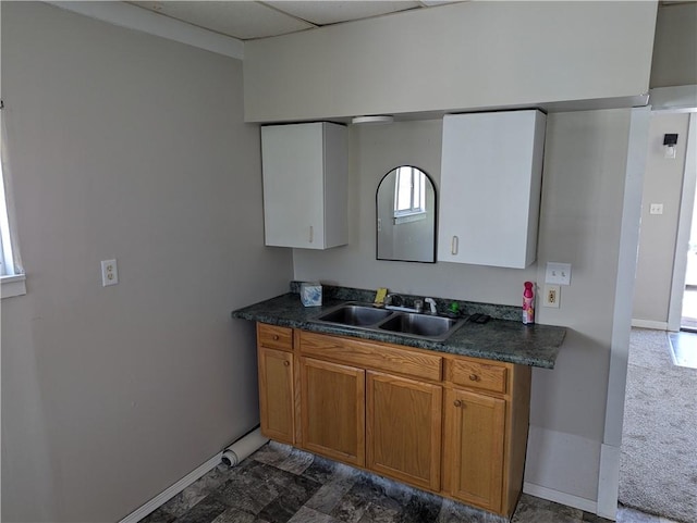 14 2nd Ave, Pt Marion, PA 15474 - kitchen with dark countertops, brown cabinetry, baseboards, and a sink