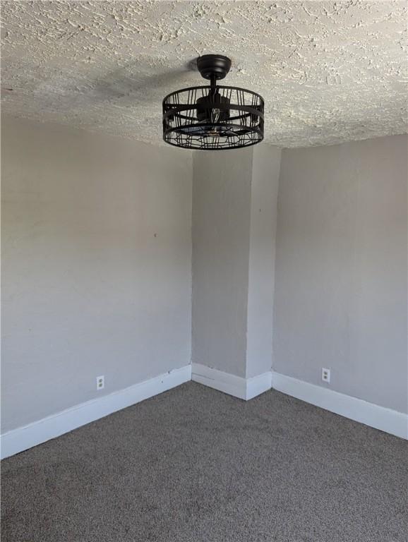 14 2nd Ave, Pt Marion, PA 15474 - unfurnished dining area with carpet floors and baseboards