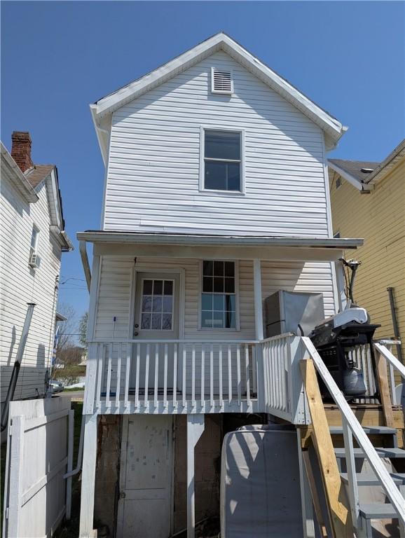 14 2nd Ave, Pt Marion, PA 15474 - back of house with an attached garage, stairs, and covered porch