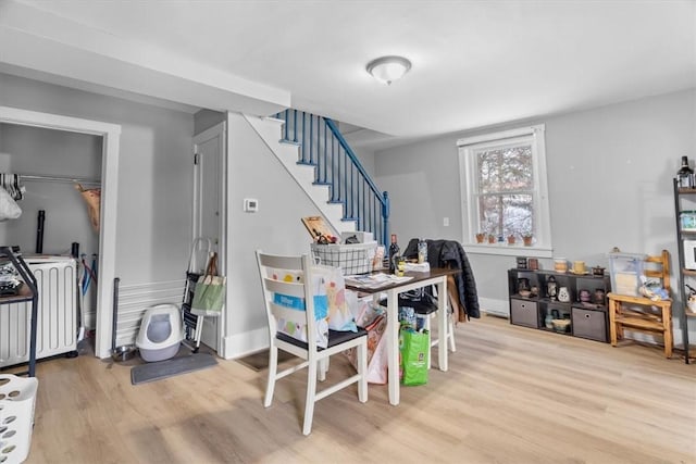 dining area featuring washer / clothes dryer and light hardwood / wood-style flooring