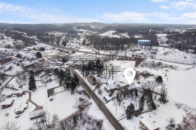 snowy aerial view featuring a mountain view