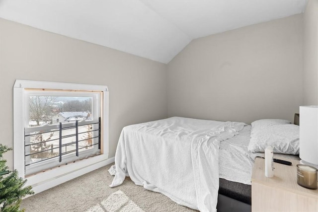 carpeted bedroom featuring vaulted ceiling